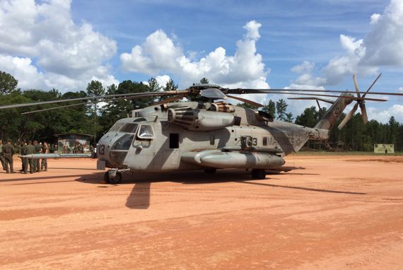 elicopter on runway near group of people